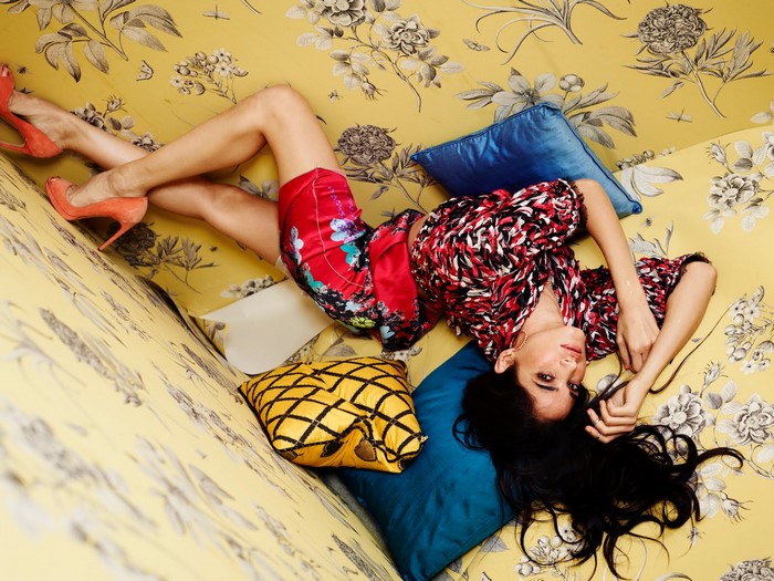 Sofia Boutella posing on a floral couch