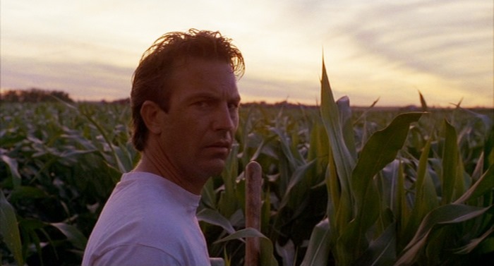 Kevin Costner in a cornfield at sunset