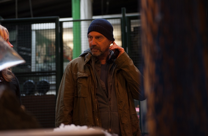 Kevin Costner wearing a beanie and jacket