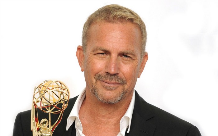Kevin Costner holding an Emmy Award