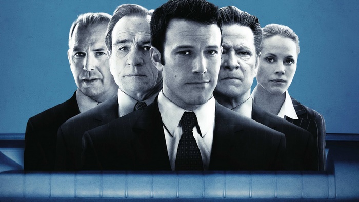 Kevin Costner and other actors in suits