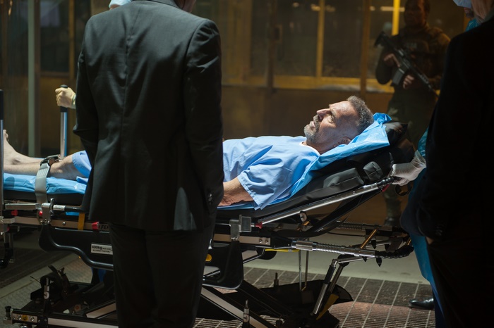 Kevin Costner on a gurney