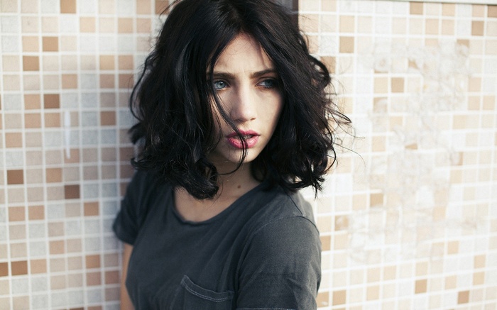 Woman with dark hair and blue eyes
