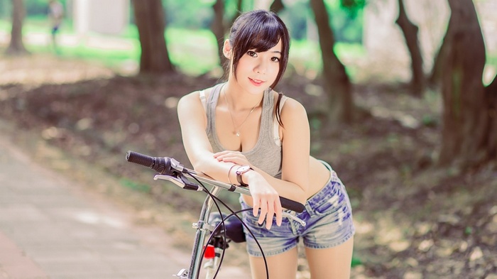 Woman with bicycle in park