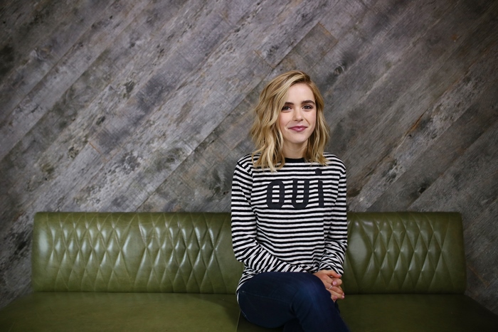 Kiernan Shipka sitting on a green couch