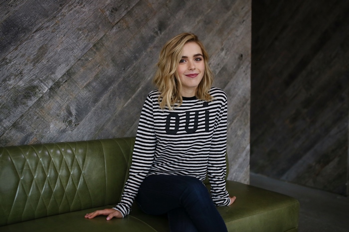 Kiernan Shipka sitting on a green couch