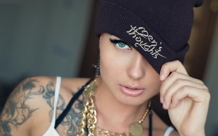 Woman with tattoos and beanie