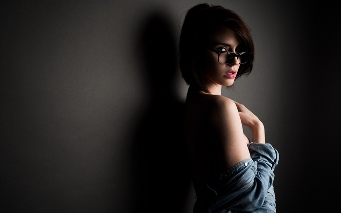 Woman with glasses wearing a denim shirt
