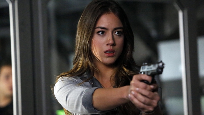 Chloe Bennet holding a handgun