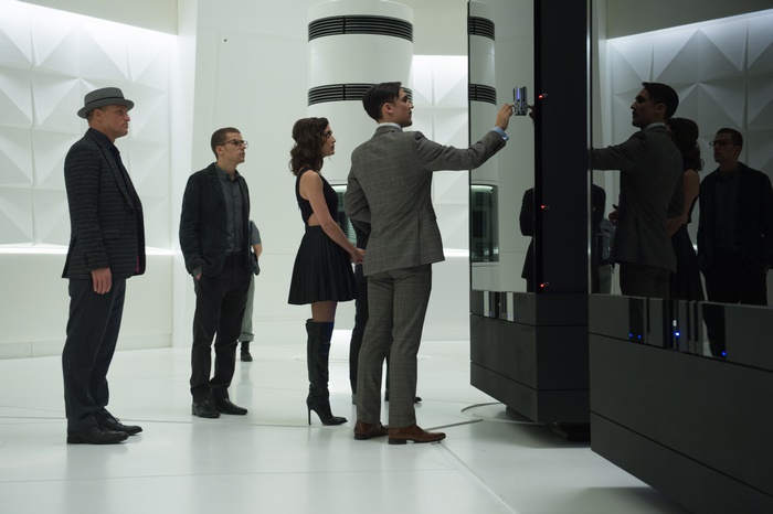 Lizzy Caplan and men in a futuristic room