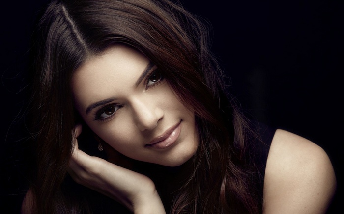 Woman with dark hair posing