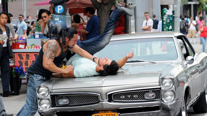 Taylor Lautner in a fight scene on a car