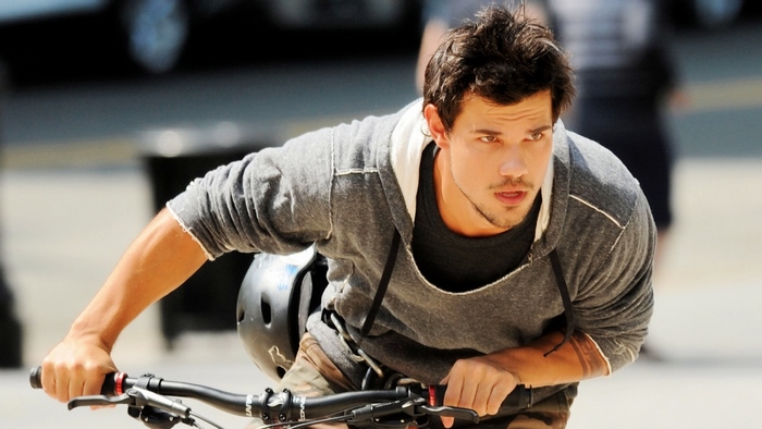 Taylor Lautner riding a bicycle