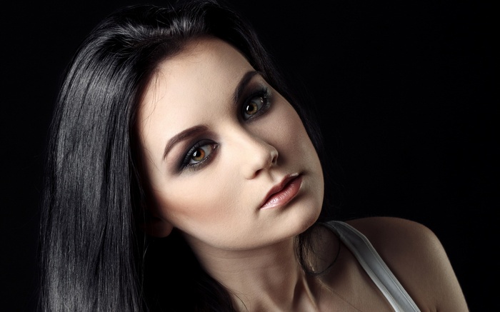 Woman with dark hair and smoky eye makeup