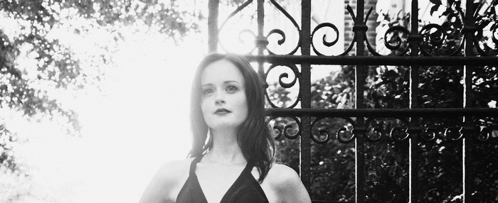 Alexis Bledel in front of a gate
