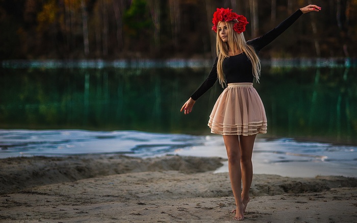 Woman with flower crown by lake