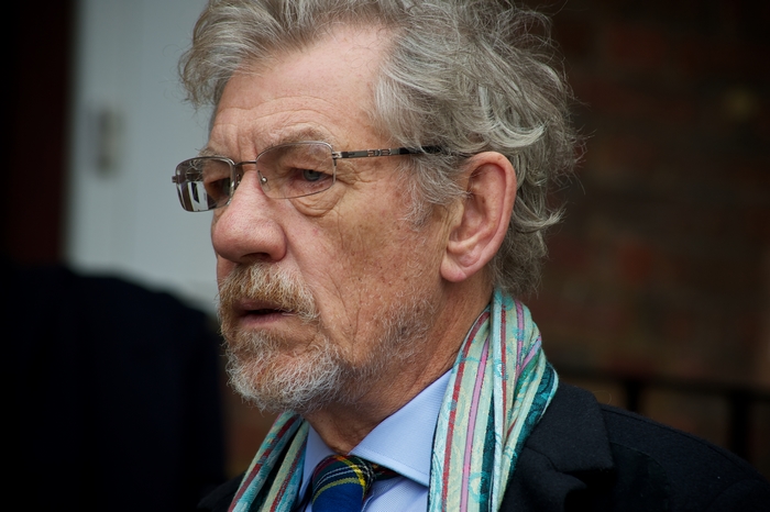 Ian McKellen wearing glasses and scarf
