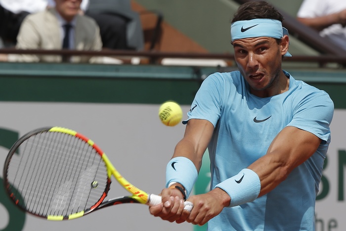 Rafael Nadal playing tennis on a clay court
