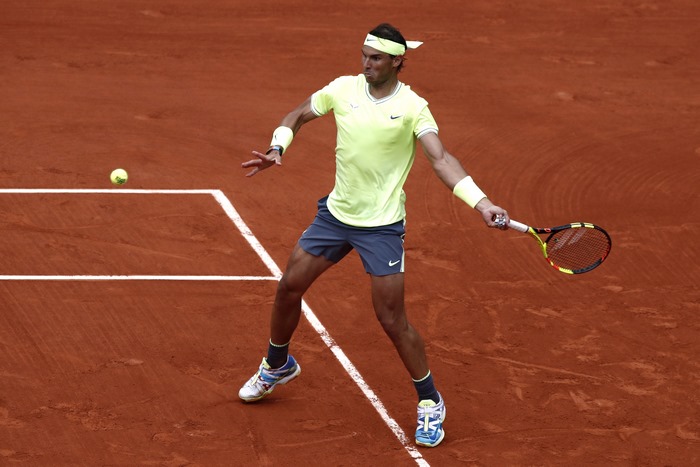 Rafael Nadal playing tennis on a clay court