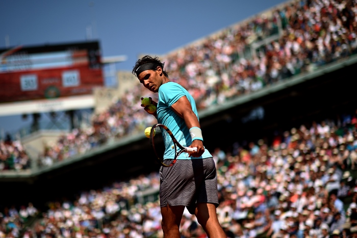 Rafael Nadal holding tennis balls and racket