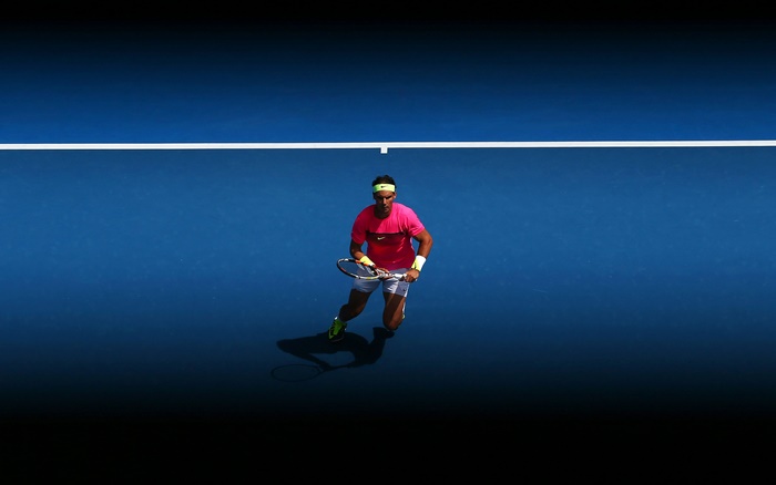 Rafael Nadal on a blue tennis court