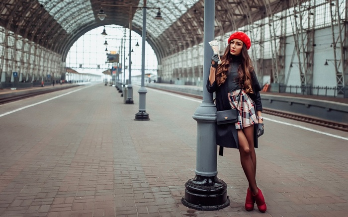 Woman in red beret at train station