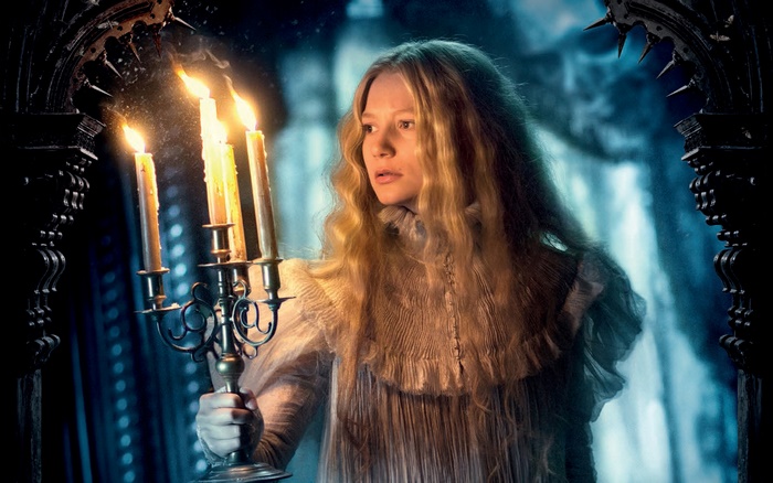 Mia Wasikowska holding candelabra