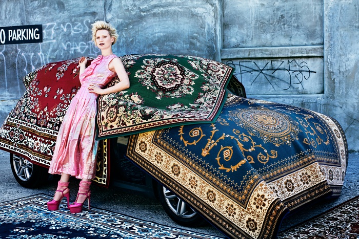 Mia Wasikowska posing with a car covered in rugs