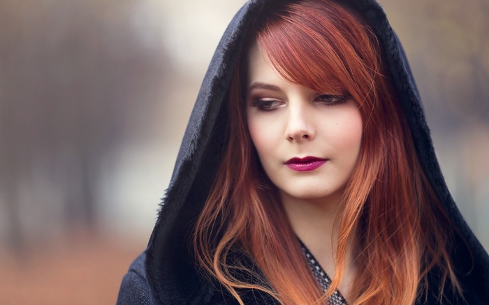 Woman with red hair wearing a hood