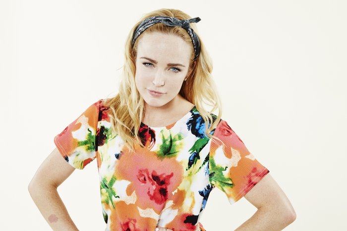 Caity Lotz wearing a floral shirt and bandana