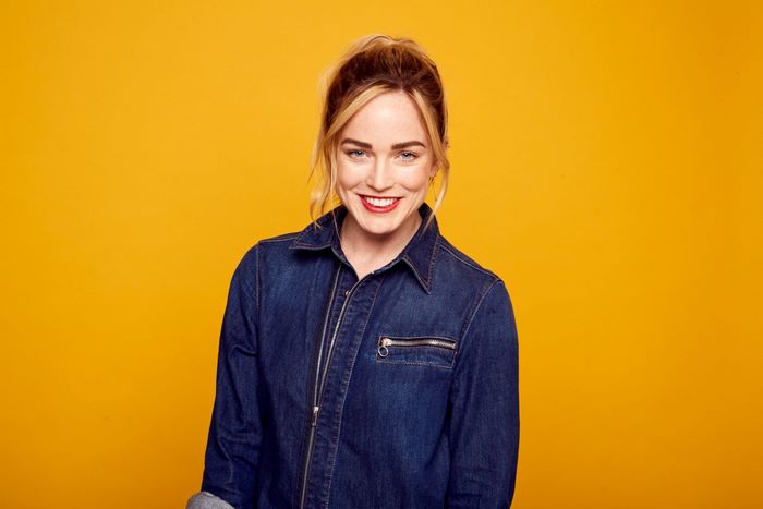 Caity Lotz smiling in denim jacket