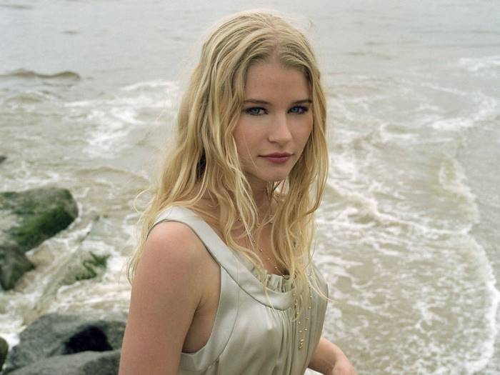 Emilie de Ravin on a rocky beach