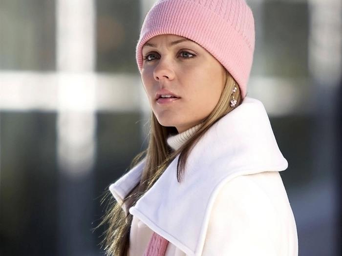 Laura Vandervoort wearing a pink hat and white coat