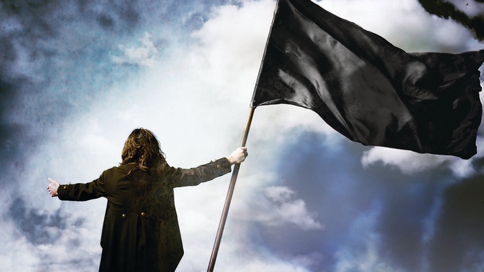 Ozzy Osbourne holding a black flag