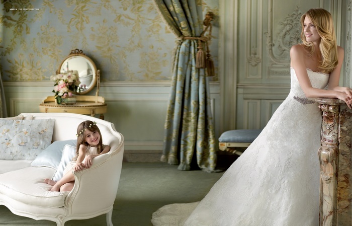 Lindsay Ellingson in a wedding dress with a young girl