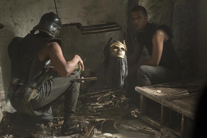 Jacob Anderson in a dark room with a mask