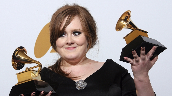 Adele holding two Grammy awards