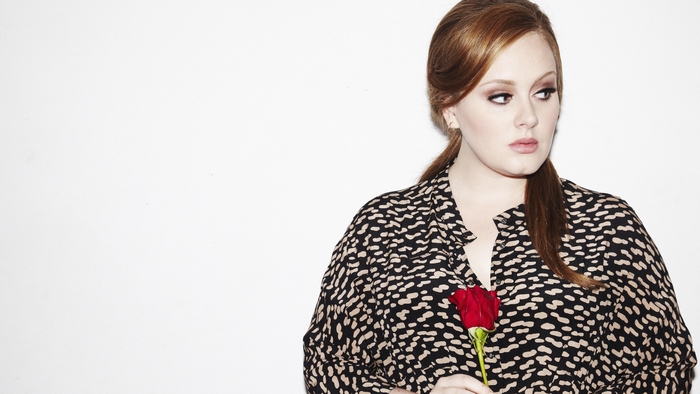 Adele holding a red rose