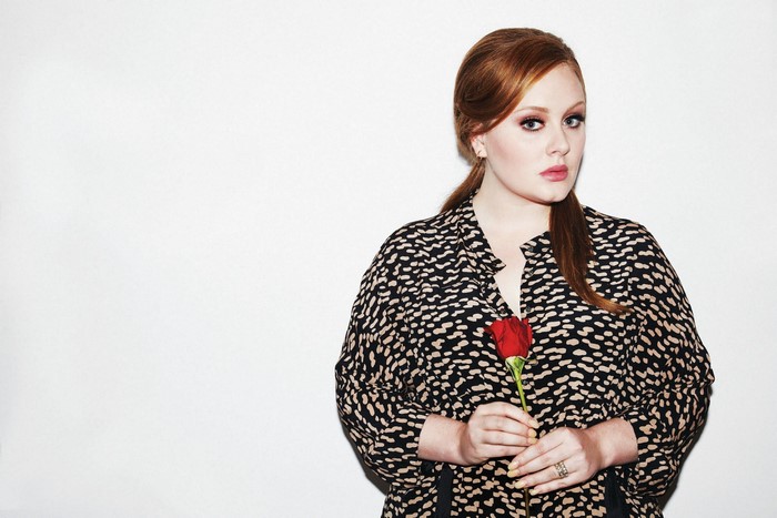 Adele holding a red rose
