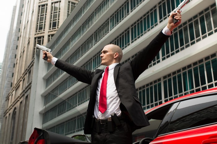 Rupert Friend as Agent 47 with guns