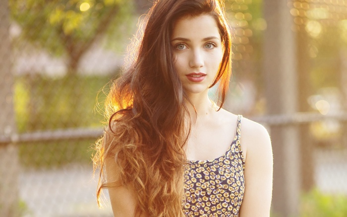 Woman with long brown hair in a floral dress