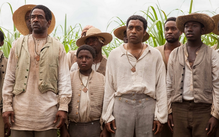 Chiwetel Ejiofor and other men in a field