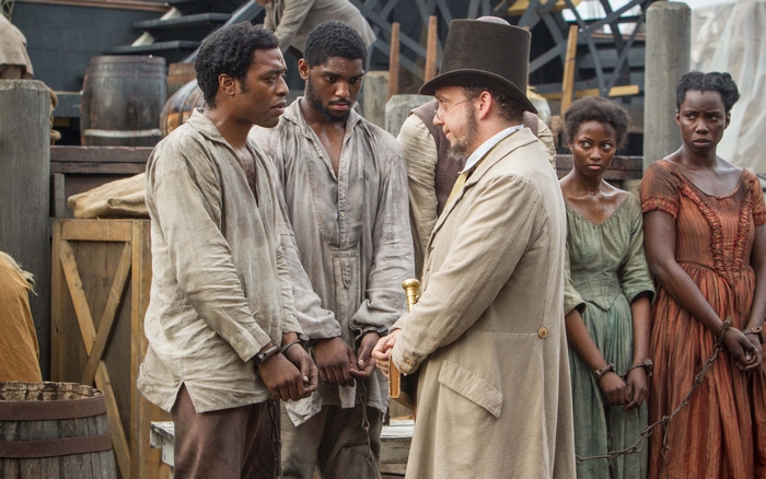 Solomon Northup and enslaved people with a man in a hat