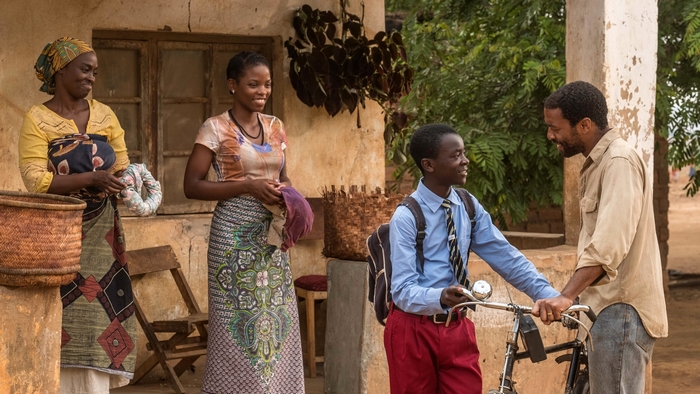 Chiwetel Ejiofor and children in a village