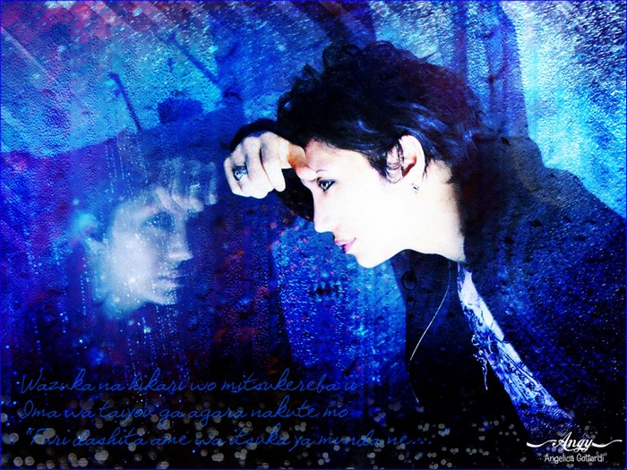 Gackt Camui reflected in a wet window