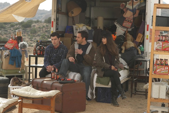 Hannah Simone and two men sitting by a truck