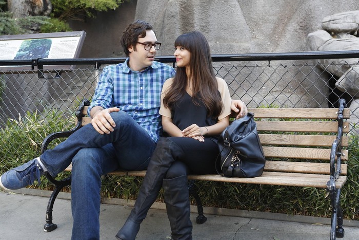 Hannah Simone sitting on a bench