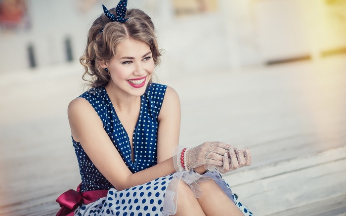 Woman in polka dot dress with hair bow
