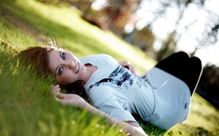 Woman lying on grass