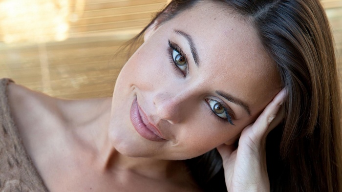 Woman with hand on her face